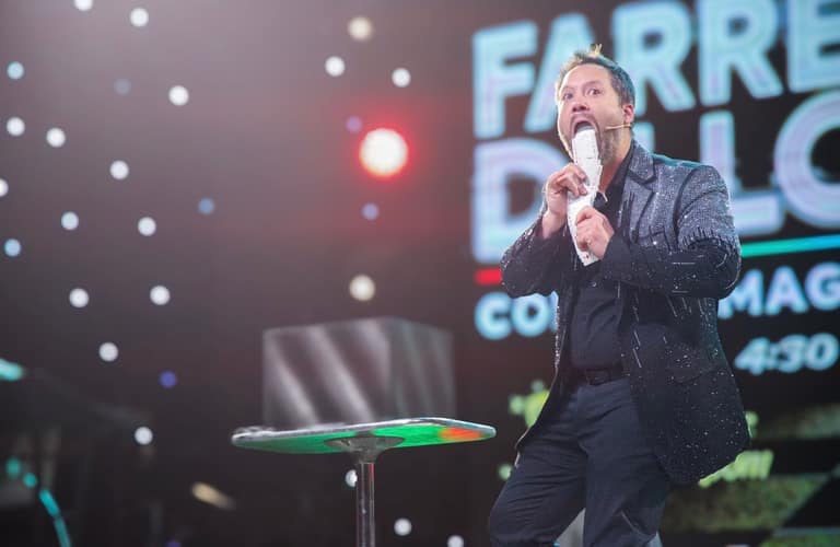 Farrell Dillon on stage with a fan of cards at his mouth